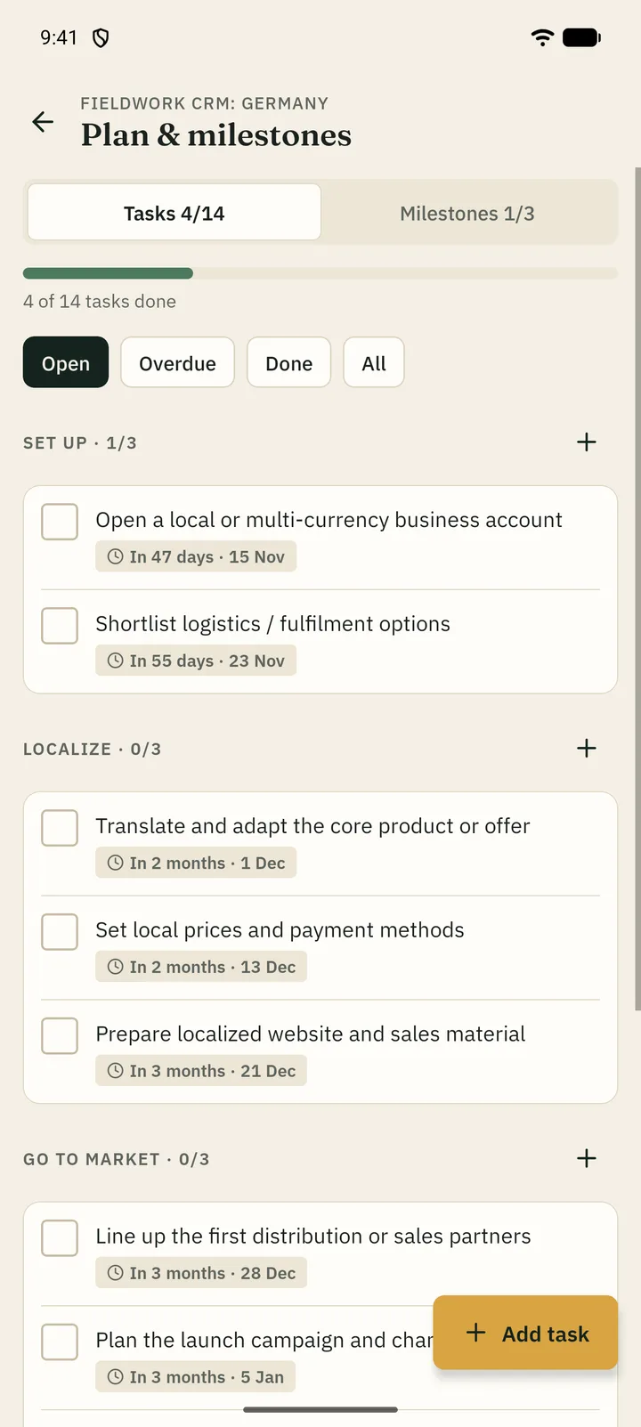 Launch plan with tasks grouped by phase, a progress bar and due-date badges.